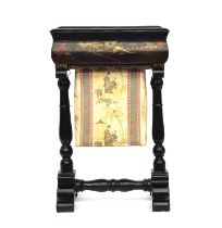 A 19th century black Japanned work table, the hinged lid opening to a fitted interior, with pull out