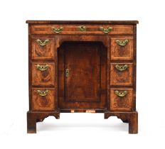 A George II walnut lady's kneehole dressing table, c.1740, quarter veneered and cross banded top