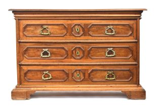 A massive 17th century Italian walnut chest of drawers, heavily moulded top over three drawers