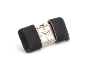 A Movado Chronometre Ermeto purse travel watch, the leather case opening to reveal a signed white