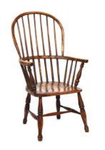 A 19th century Windsor chair, ash and elm, stick back, turned underarm supports, on ring turned legs