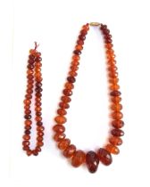 A faceted amber bead necklace, the beads graduating from 1.2cm to 3.5cm diameter, fastening with a