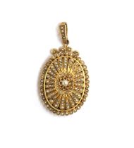 A Victorian yellow metal locket, profusely set with seed pearls in rayed petal shaped settings,