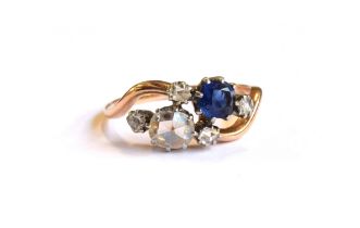 An early 20th century 18ct gold 'Toi et Moi' diamond and sapphire crossover ring, the large rose cut