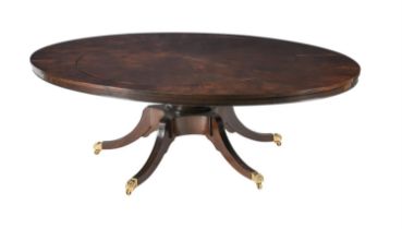 A mahogany concentric extending dining table in Regency style, with four additional elliptical