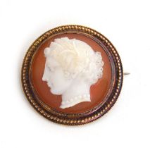 A Victorian gold mounted well carved hardstone cameo brooch of a classical lady in profile, within