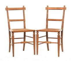 A pair of light oak and caned side chairs in the manner of James Shoolbred, the octagonal faceted