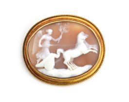 A gold mounted carved shell cameo brooch, depicting the Goddess Diana in her chariot, unmarked but