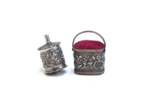 A mid 19th century silver tape measure, of cylindrical form with all over chased floral rose,
