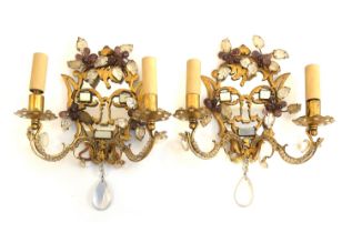 A pair of unusual early 20th century gilt metal and moulded glass two arm wall sconces, mirrored