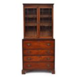 A 19th century mahogany glazed secretaire bookcase, with two adjustable shelves, over a fitted