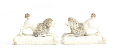 Two 19th century biscuit porcelain models of poodles on cushion form base, encrusted hair detail,