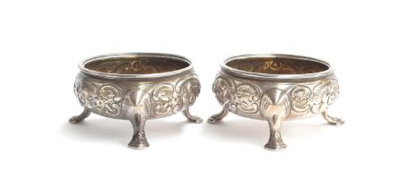 A pair of George III silver salts, marks rubbed, with silver gilt interiors, later chased with