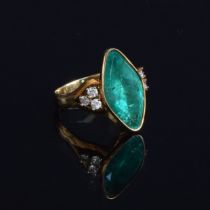 An impressive 18ct yellow gold ring set with a large navette shaped emerald, estimated 9.35