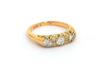 An 18ct gold and diamond ring, three larger diamonds interspersed with four small diamonds,