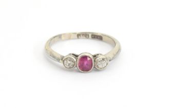 An early 20th century 18ct white gold and platinum ruby and diamond trilogy ring, each set with