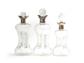 Three silver collared glug decanters: J. Sherwood & Sons, Birmingham 1898, 26.5cm high; Goldsmiths &