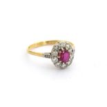 An 18ct gold ruby and diamond cluster ring, unmarked but tests as 18ct gold, size O, 2.2g