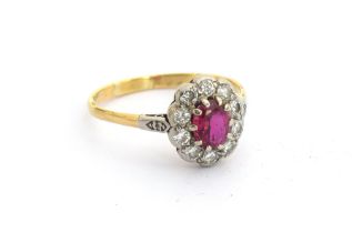 An 18ct gold ruby and diamond cluster ring, unmarked but tests as 18ct gold, size O, 2.2g