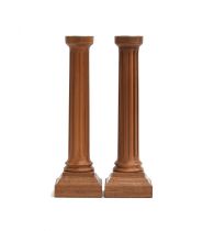 A pair of David Linley walnut candlesticks, chrome nozzles raised on fluted columns and square base,