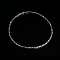 An impressive 18ct white gold riviere necklace set with alternating brilliant cut and baguette cut