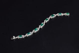 An exquisite 18ct white gold emerald and diamond bracelet, the eight large emeralds approx. a