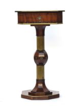 A Regency walnut and brass musical sewing table, the hinged top with central mother of pearl lyre