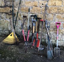 A quantity of vintage garden tools to include forks, rakes, spades, etc