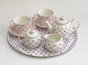 A Nina Campbell pink heart china tea set for two comprising teacups, saucers, teapot, milk jug,