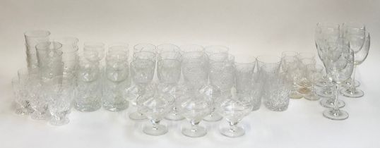 A large quantity of cut glass to include tumblers, wine glasses, trifle dishes etc