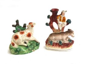 A Staffordshire pearlware recumbent ewe, 11cmH; together with a Staffordshire donkey and lady in