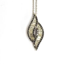 A 14ct white gold pendant of entwined form, baguette cut diamonds surrounded by black diamonds, 2.