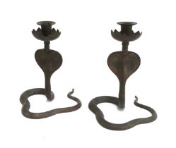A pair of Cairoware cobra form candlesticks, 21.5cmH