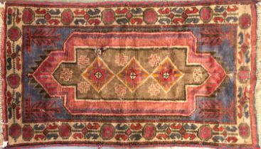 A small Persian wool rug, 140x81cm