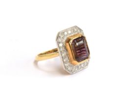 An 18ct gold cluster ring set with an emerald cut bicolour pink tourmaline, approx. 8cts, surrounded