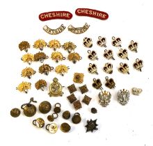 A collection of Cheshire regiment cap badges, buttons etc, in a wooden box etc