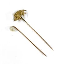 Two Victorian yellow metal stickpins, one set with a pearl, the other a running boar with ruby eyes,