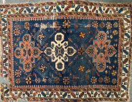 A Caucasian wool rug (af), three central medallions on a blue ground, 150x116