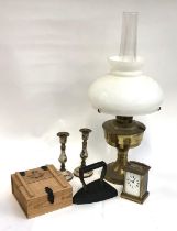 METAL WARES: an oil lamp with chimney and shade together with a French carriage clock (a/f) and a