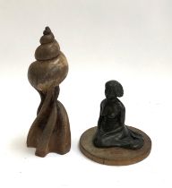 Two sculptures by the same artist, a carved wooden sculpture of a shell, 29cmH, and a figure of a