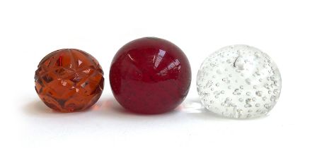 Three Whitefriars paperweights: red and clear bubble paperweight, together with an orange faceted