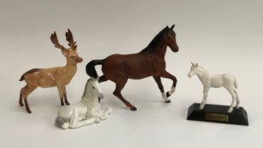 A collection of Beswick and other figurines to include stag, matt foal, chestnut horse etc