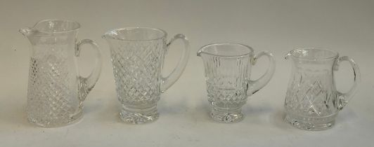 Four cut glass water jugs: two Waterford and two Stuart, 15cmH to 20cmH