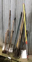 A quantity of vintage garden tools to include rakes, snow shovel, spades, axes, etc