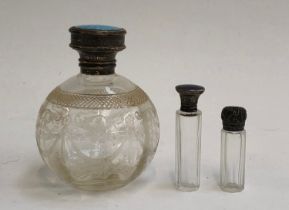 Three silver topped glass scent bottles, two with guilloche enamel lids, the tallest 12cmH