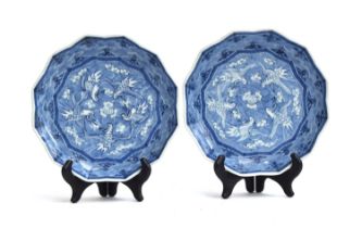 A pair of Japanese Arita porcelain shallow dishes of twelve-pointed form, each depicting five herons