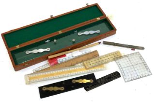 A mixed lot of rulers and slide rules, one in wooden case; together with a vintage thermometer