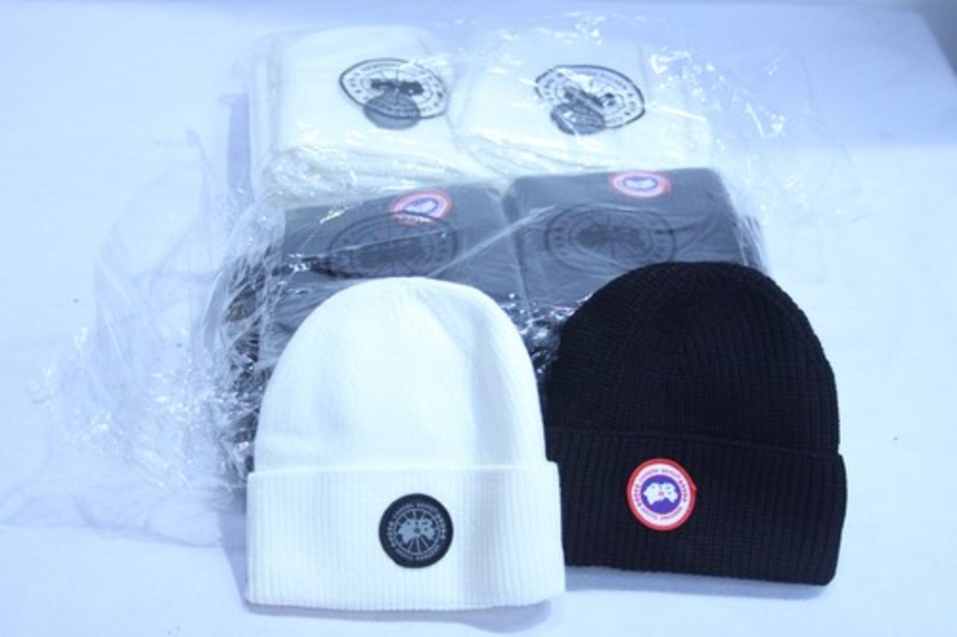 Approximately 20 x cream and black beanie hats -new with tags (E4B)