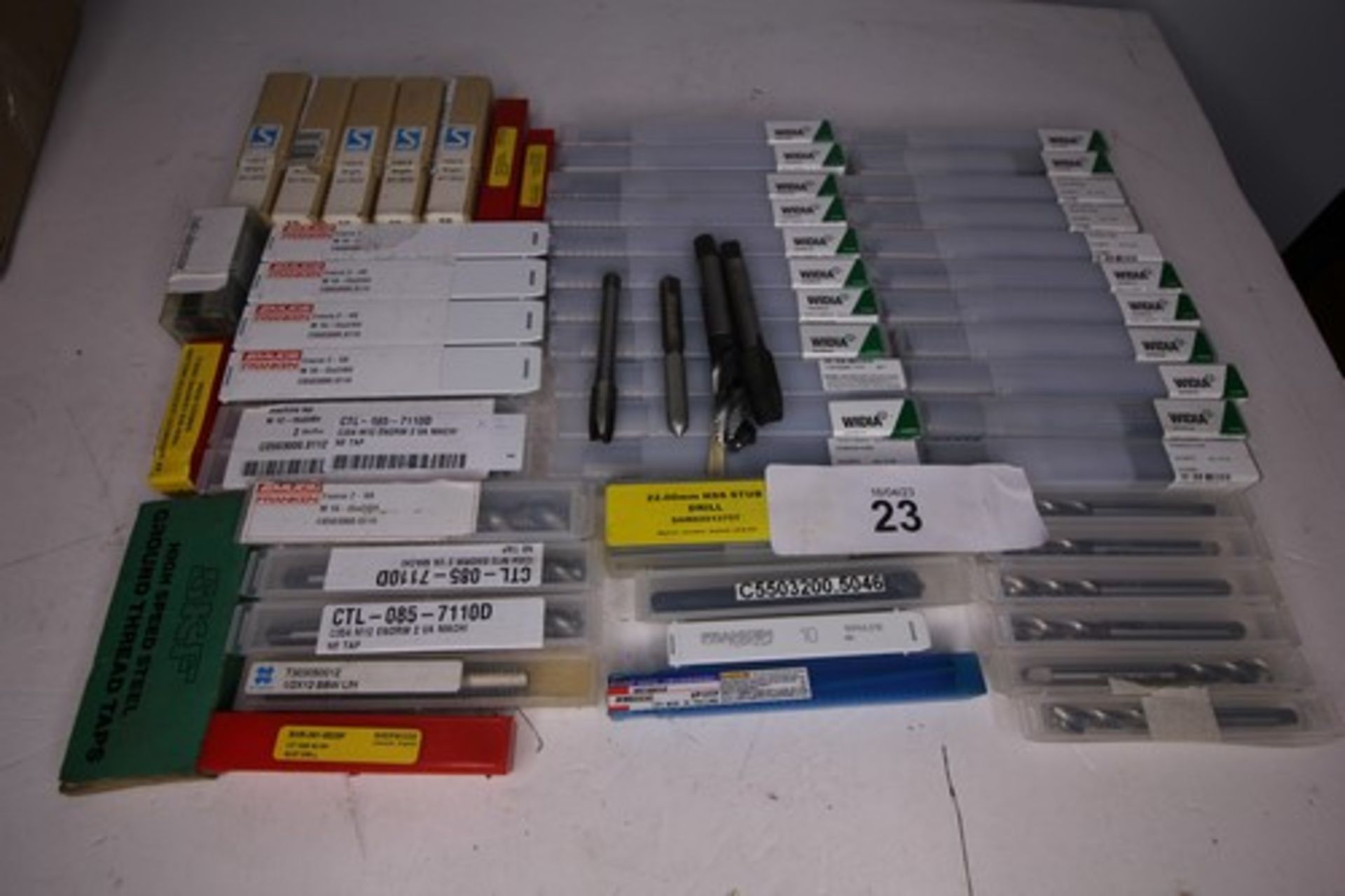 A selection of drill bits and taps including Widia WU25PD 14.3mm, C354M16 Enrom machine tap, 22mm