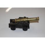 A brass and cast metal model cannon